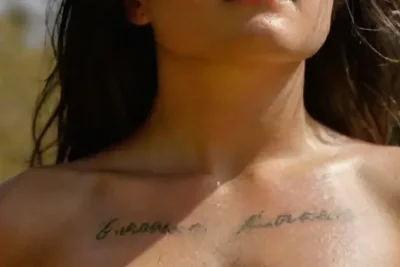 Woman with tattoos outdoors in sunlight