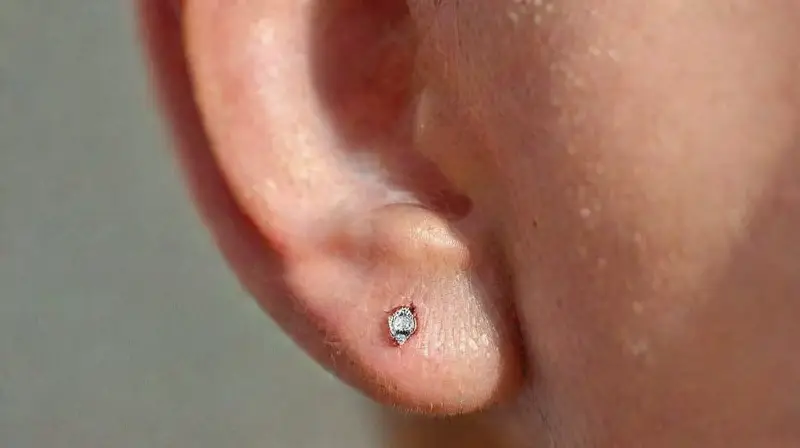Close-up of pierced nose and ear