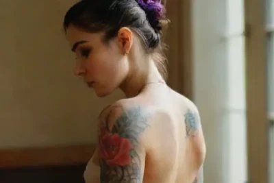Woman with colorful tattoos in professional setting