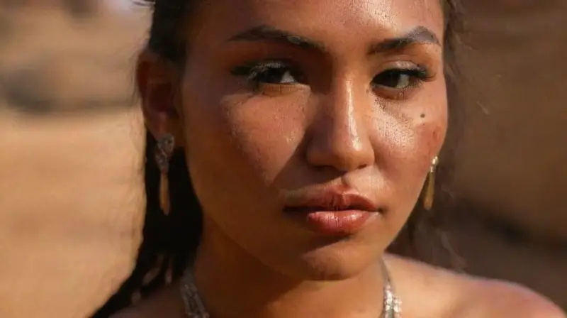Native American woman with piercings and face paint