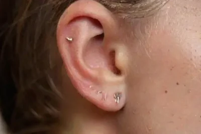 Close-up of detailed ear with piercing
