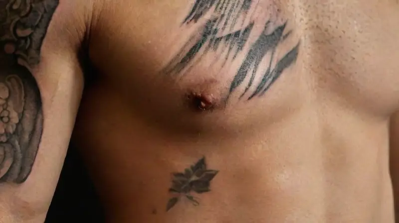 Close-up of intricately tattooed, realistic torso