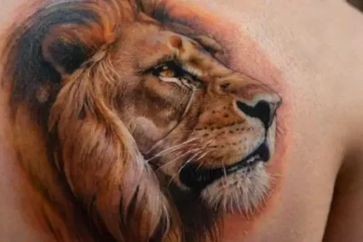 Hyper-realistic lion tattoo with detailed shading
