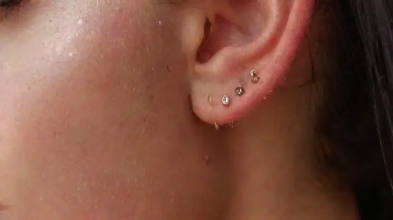 Close-up of decorated pierced womans ear