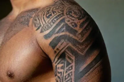 Close-up of arm with intricate tribal tattoo