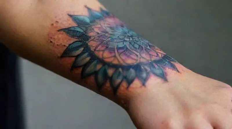 Vibrant, intricate mandala tattoo on forearm